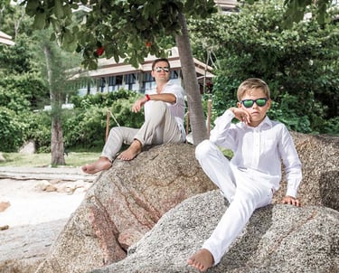 Father and son posing on rocks during Koh Samui family photoshoot