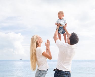 Parents lifting baby above sea during Koh Samui photoshoot