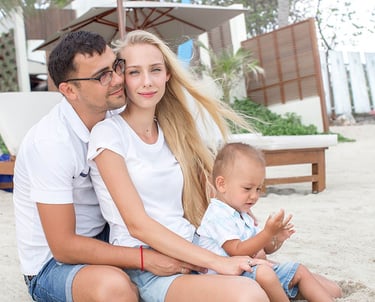 Young family sitting on sandy beach during Koh Samui photoshoot