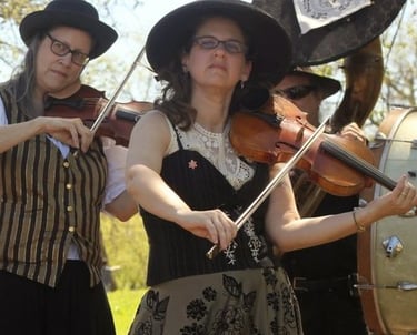 Jennifer Marshall playing violin during a Mazel Tov performance