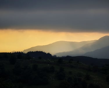 Sunset over mountains with Autumn light and haze in the Lake District Near Ambleside