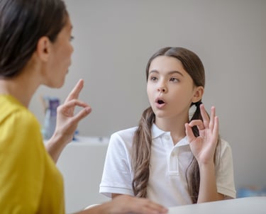 a woman talking on her cell phone while holding a cell phone