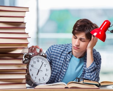 a man sitting at a desk with a clock and a clock
