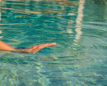 a person holding a frisbee in a pool