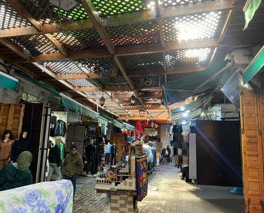 a man standing in a market place with a lot of people
