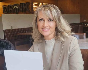 a woman sitting at a table with a piece of paper