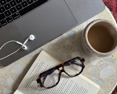 a laptop computer and a cup of coffee on a table
