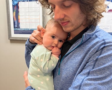 Happy baby falling asleep during their adjustment by Franklin pediatric chiropractor