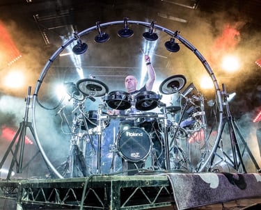 a drum kit with a circular rig on stage
