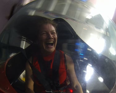 a woman in an open simulator cockpit