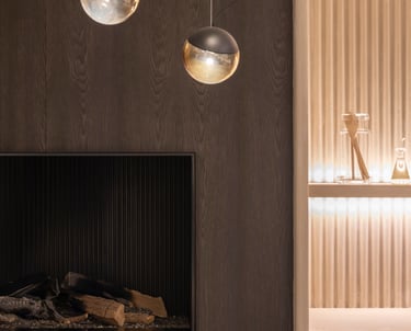 interior design example of renovated fireplace with a golden background wall and accent lighting