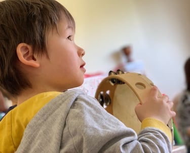 Young child holding a tambourine
