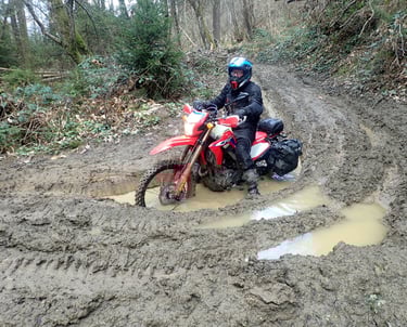 a person riding a dirt bike in the mud