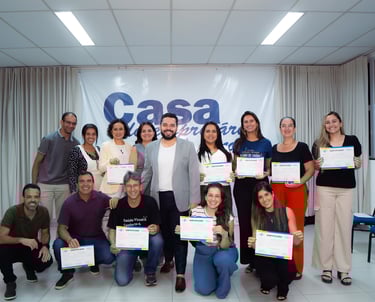 a group of people standing around a table with certificates