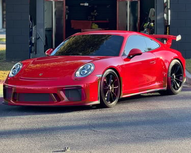 a red sports car parked in front of a building