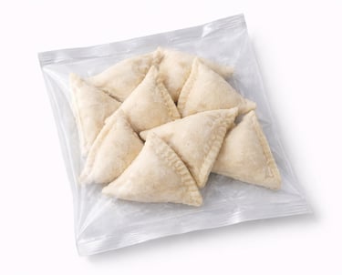 Frozen stuffed samosas prepared for frying and export-ready distribution