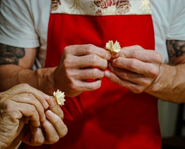 Hands shaping traditional Sardinian pasta during a cooking class.