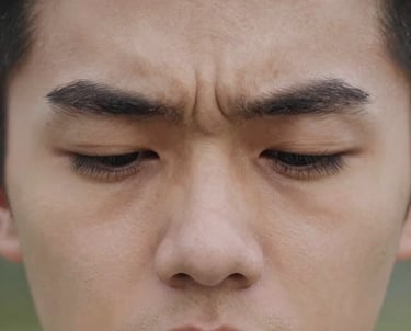 Focus on the delicate eye area showing subtle crow's feet.