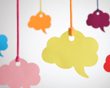 a bunch of colorful speech bubbles hanging from a string