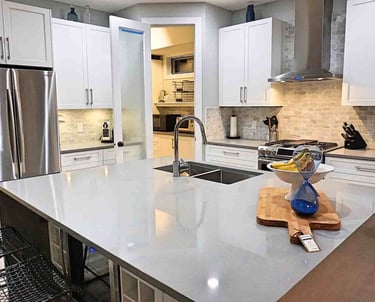 High gloss countertop and white kitchen cabinets euro-style in a kitchen in lake country