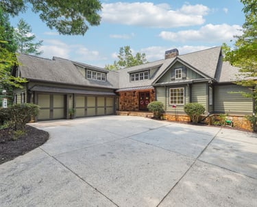 a large house with a driveway showing achasta real estate