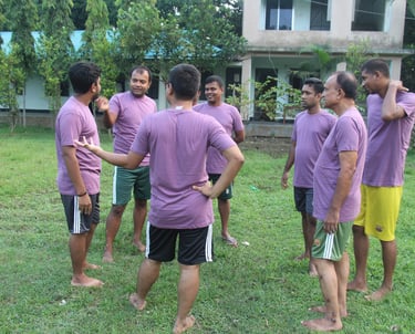 a group of men standing around a soccer ball