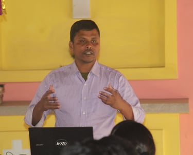 a man standing in front of a laptop computer