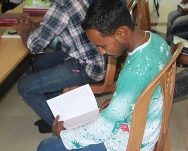 a man sitting in a chair with a book