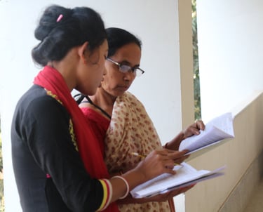 two women standing in front of a building