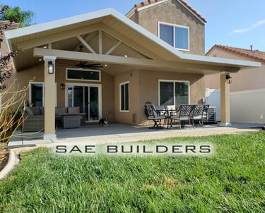 Alumawood patio cover with gabled roof line, lights, and ceiling fan. Color is Latte & White.