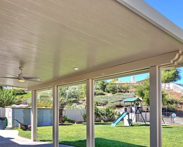 Insulated Alumawood patio cover with playground set in background