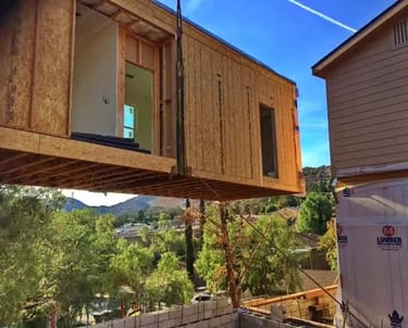 Modular home lifted with a crane to set on founation.
