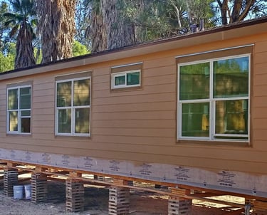 Manufactured home built off site with cement siding.