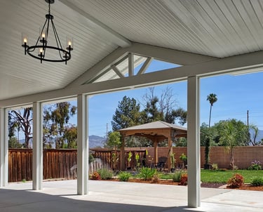 Alumawood patio cover with gabled center section and hanging light fixture. Color is white.