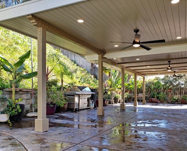 Beautiful wood patio structure with tounge and groove ceiling, beams, fans, and lights.