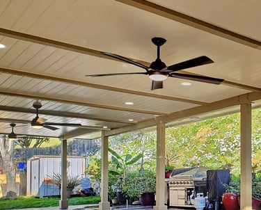 Custom wood patio cover creating a beautiful outdoor living space with lights and fans. Located in Escondido, California,