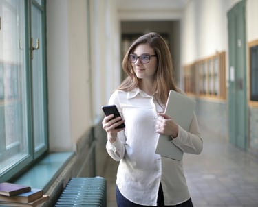 Confident mother holding a notebook in a school hallway, prepared for her child's IEP meeting