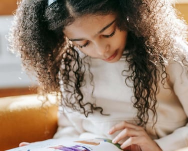 A young girl reading a children's picture book.
