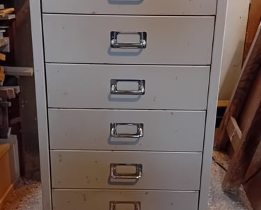 Dull grey metal set of filing drawers with metal handles
