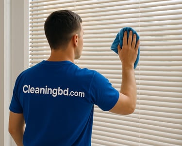 A Man cleaning window a window blinds