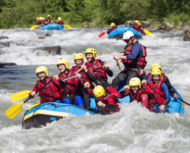 a group of people in rafters on a river