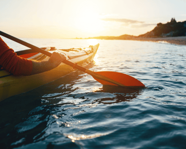 a person in a kayak kayak in the water