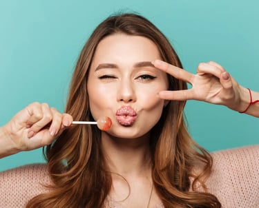 a woman with a pink lippy and a lollipop in her mouth