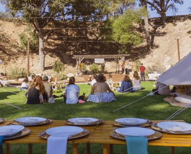 a group of people sitting around a table with plates and plates retreat event planner