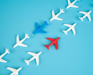 a group of airplanes flying over a blue sky