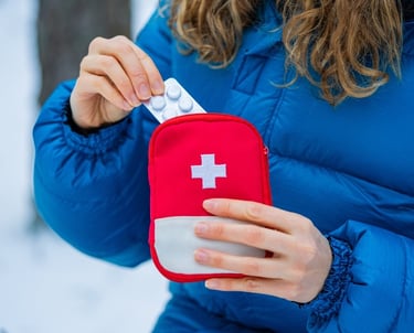 a woman in a blue jacket and a red cross - body bag