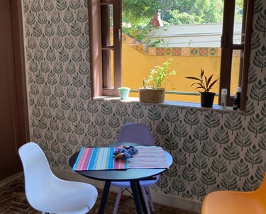 a table with a table and chairs in front of a window