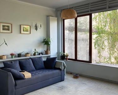 a couch in a living room with a large window