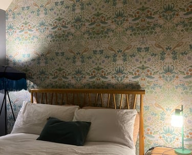 a bed with a lamp on top of it