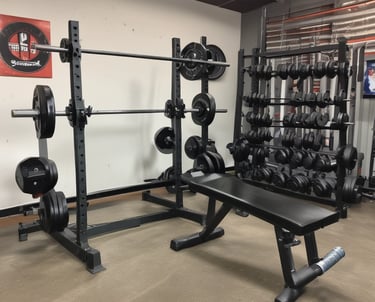 Front of a meal preparation business with a dark blue door and a large window displaying the name 'MEALPRO' and the slogan 'For the athlete in you.' The exterior features an orange awning and a small patch of greenery. A parked car is visible in the reflection of the window.